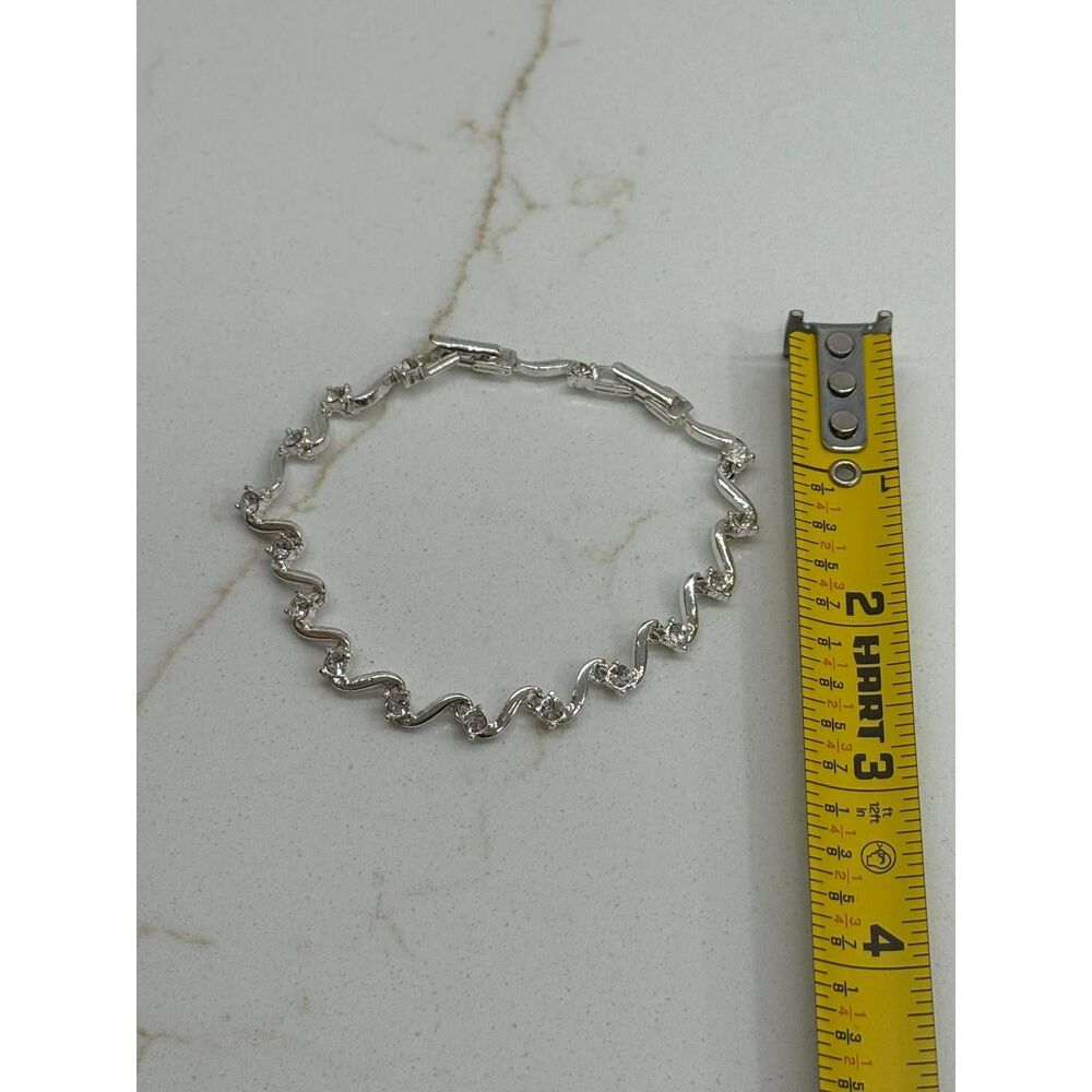 Avon Mackenzie Swirl Tennis Bracelet Silvertone Rhinestone – New in Box